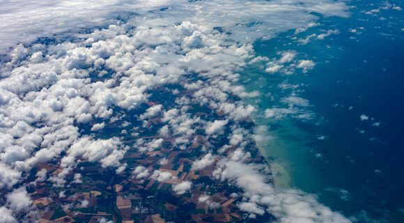 satellite imagery of coast covered with clouds